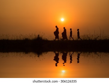 Silhouette Of Monk Walk On The Field  , Thailand