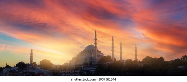 Silhouette of a mosque with minarets at orange sunset in Istanbul