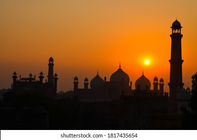 silhouette of a mosque and it's towers and moon with blue and orange warm background - Powered by Shutterstock