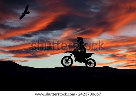 Silhouette of motocross rider at sunset. Extreme sports and twilight.