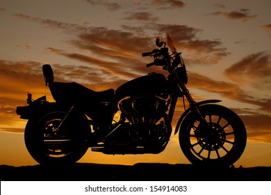 A silhouette of a motorcycle from a side view.