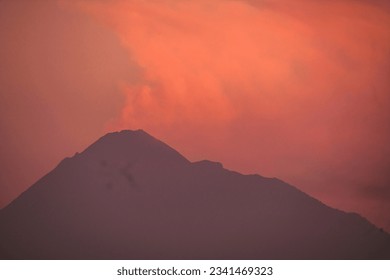silhouette of a mountain with goldenhour sky