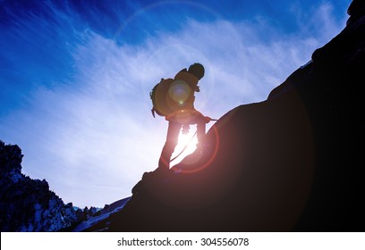 Silhouette of mountaineer and sunset. - Shutterstock ID 304556078
