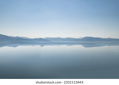 Silhouette of mountains near lake at the early morning with clear sky - Powered by Shutterstock