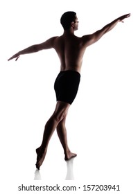 Silhouette Of An Muscular Adult Male Modern Contemporary Ballet Style Dancer. Dancer Is Wearing Black Ski Pants And Is Isolated On A White Background.