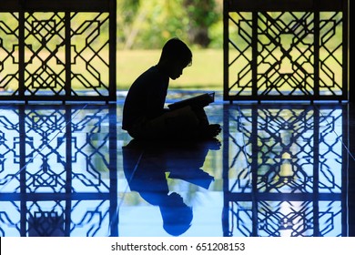 Silhouette Of A Muslim Kids Reciting Al-quran At Mosque.