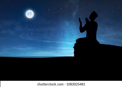 Silhouette Of Muslim Man Praying To God At Night