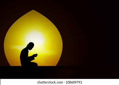 Silhouette Of A Muslim Praying At Sunset During The Month Of Ramadan