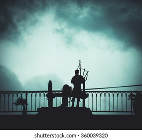 Silhouette Of New Orleans Bagpipe Player And Cannon

