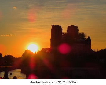 The Silhouette Of Notre Dame De Paris In Front Of The Sunset