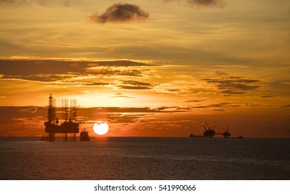 Silhouette of Offshore Jack Up Rig in The Middle of The Sea at Sunset Time. For produce oil and gas fuel.