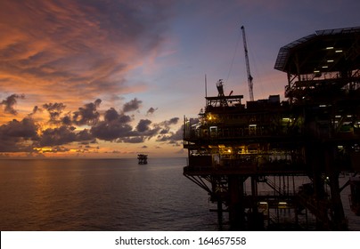 Silhouette Of An Offshore Oil Rig At Sunset