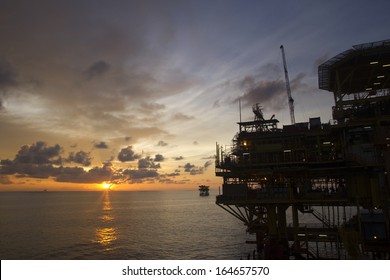 Silhouette Of An Offshore Oil Rig At Sunset