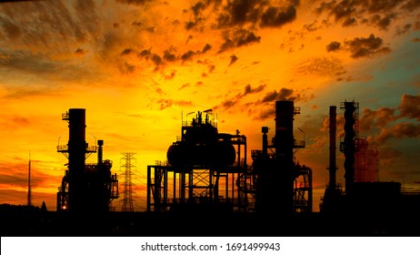 Silhouette of  oil refinery factory during sunset.
