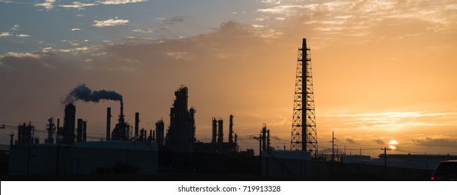 Silhouette Oil Refinery At Sunrise. Oil Factory, Petrochemical Plant Tower, Gas Flare, Smoke Stacks And Machinery In Corpus Christi, Texas, USA. Petroleum Industry Background. Panorama Style.