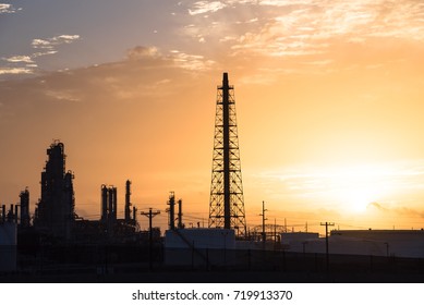 Silhouette Oil Refinery At Sunrise. Oil Factory, Petrochemical Plant Tower, Gas Flare, Smoke Stacks And Machinery In Corpus Christi, Texas, USA. Petroleum Industry Background.