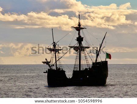 Silhouette Of Old Fashioned Galleon With Cloudy Sky In Background At Dusk - Image
