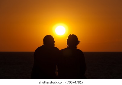 Silhouette Older Couple Watching The Sunset In, Spain Beach 