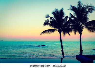 Silhouette palm tree and Beautiful luxury hotel swimming pool at twilight times - Vintage Filter