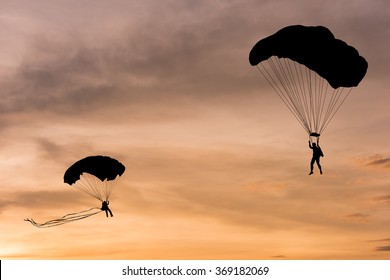 Silhouette of parachute on sunset background
