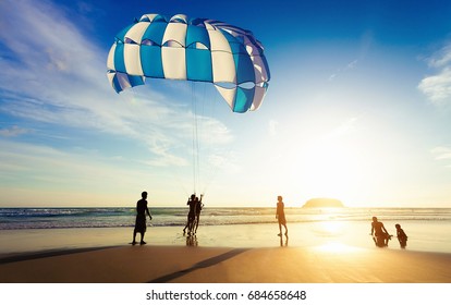 Silhouette of Parasailing at Kata beach with sunset background, Phuket, Thailand