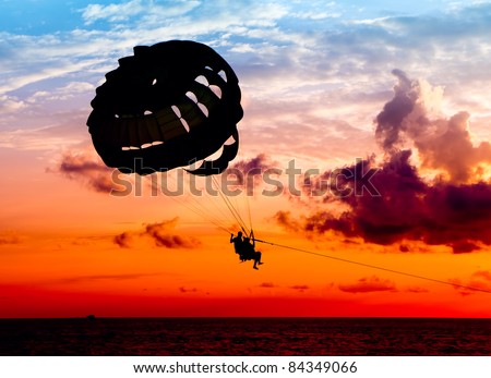 Silhouette of a para-sailor at sunset