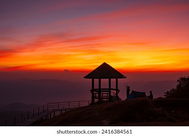 Silhouette pavilion by the hill during the dusk sky with tourists camping on the Doi Pui Co mountain in Mae Hong Son province Thailand. Scenic landscape, Hiking trail, and camping in Northern Thailand - Powered by Shutterstock