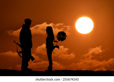 Silhouette Of Peace And Love Versus War And Anger. No War, Soldier And Girl, Weapon And Flower Toy, Peace In World, Sunset, Landscape