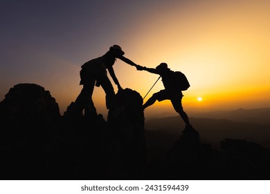 silhouette of People helping each other hike up a mountain at sunrise. Giving a helping hand, and active fit lifestyle concept. help and success concept,  Leadership Concept, teamwork. - Powered by Shutterstock