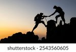 Silhouette of People helping on peak mountain and sunrise background climbing team work success business concept. People on peak mountain climbing helping team work.