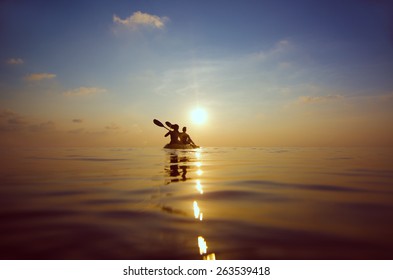 silhouette of people kayaking at sunset - Powered by Shutterstock