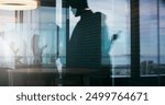 Silhouette, people and phone at window for business, contact and appointment arrangement in office. Female consultant, mobile and businessman on balcony for meeting, communication or scheduling app