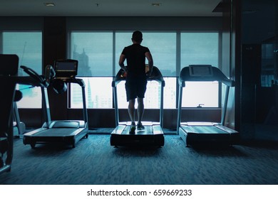 Silhouette People Running In Machine Treadmill At Fitness Gym