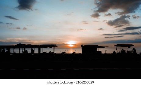 Silhouette People Standing Beach. Car Driving On Road. Landscape View Street Foods Night Market Evening Sunset . 