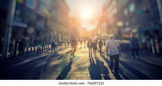 Silhouette Of People Walking On The Street Of Big City 
