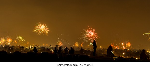 Silhouette Of People Watching Fireworks On The Rooftop Of A Building On USA's Independence Day, July 4th, 2016,  LA, CA, USA