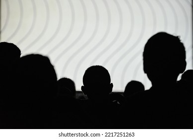 Silhouette of people watching a movie during an itinerant film exhibition on the banks of the Guaporé-Itenez river, Versalles, Beni Department, Bolivia, on the border with Rondonia state, Brazil - Shutterstock ID 2217251263