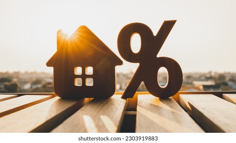 Silhouette of Percentage and house sign symbol icon wooden on wood table. Concepts of home interest, real estate, investing in inflation.	 - Shutterstock ID 2303919883