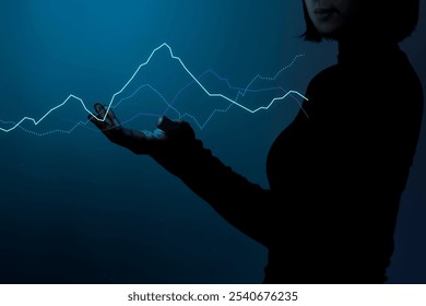 Silhouette of a person holding a digital business graph. The graph, digital and glowing for data analysis. Dark background highlights the digital business graph. Business graph overlay. - Powered by Shutterstock