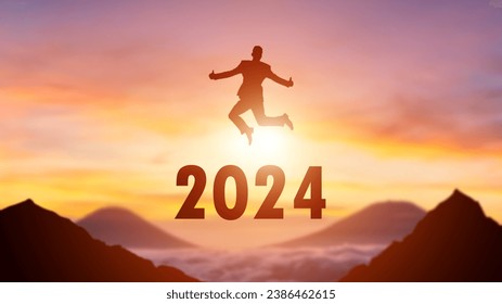 Silhouette of a person leaping from 2023 to 2024 on the top of the mountain background. Happy New Year and Christmas day concept. - Powered by Shutterstock