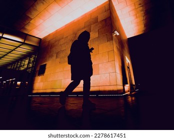 silhouette of person on night city street