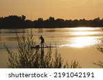 Silhouette of person paddle boarding on the Columbia River in Tri-Cities Washington 