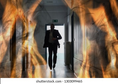 Silhouette Of Person Running Out Of Fire Escape On Corridor Of Building