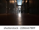 Silhouette of a person stepping into the light at the end of a dark corridor. After life concept. copy space
