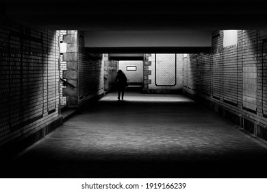 silhouette of the person in underground tunnel of train station