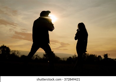 Silhouette Of Photographer And Mannequin At Photography Outdoor