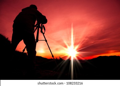 Silhouette of photographer on the top of mountain - Powered by Shutterstock