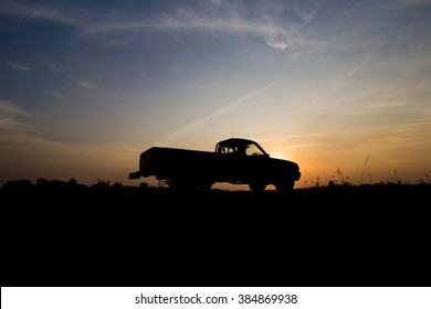 Silhouette Of Pickup Truck On The Background Of Beautiful Sunset