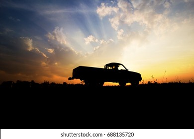 Silhouette Of Pickup Truck On The Background Of Beautiful Sunset