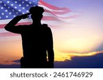 Silhouette of police man with USA flag against the sunset. National Police Week concept